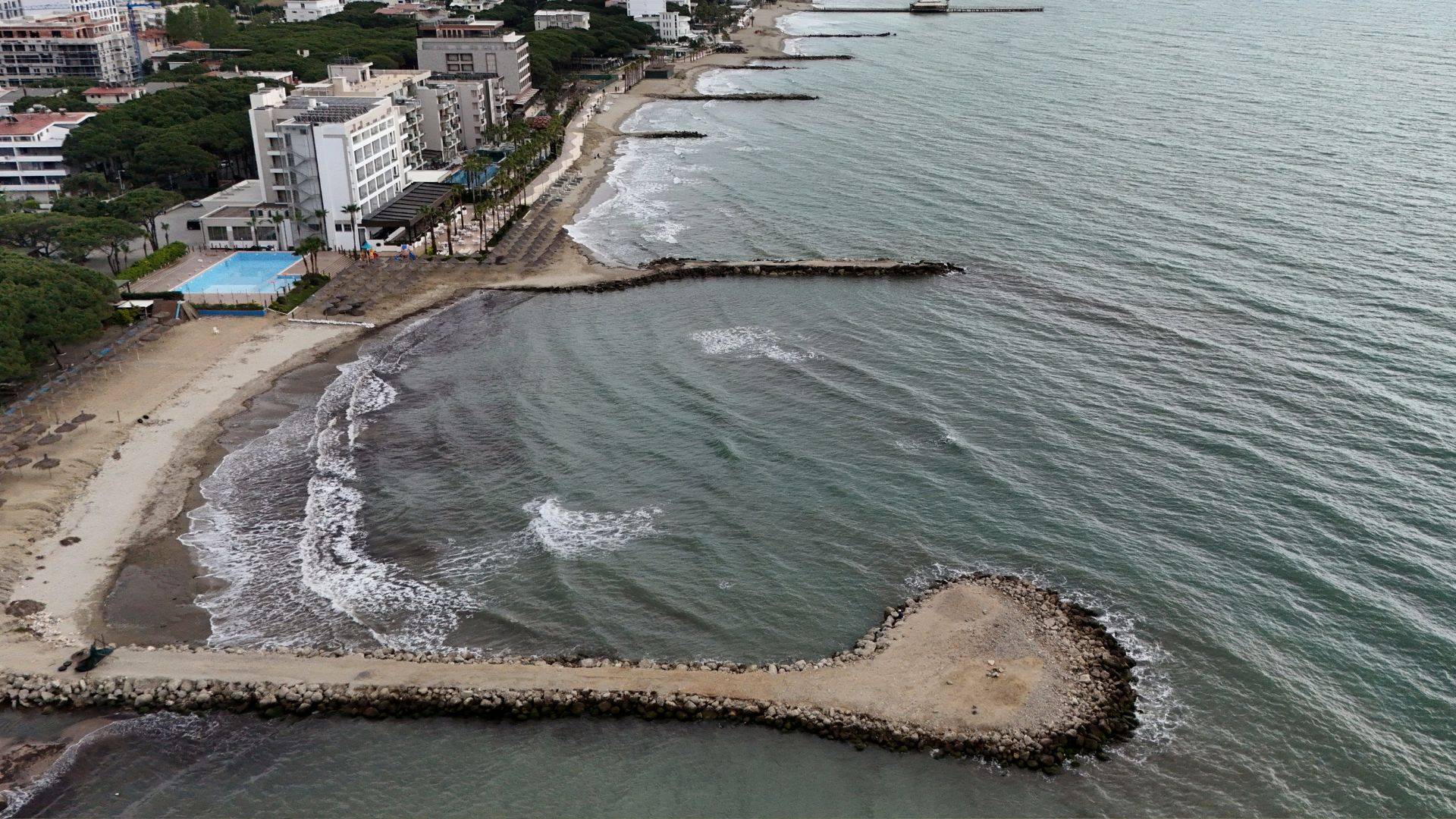 This aerial view shows dikes built along the coast to curb coastal erosion. 
/Adnan Beci/AFP
